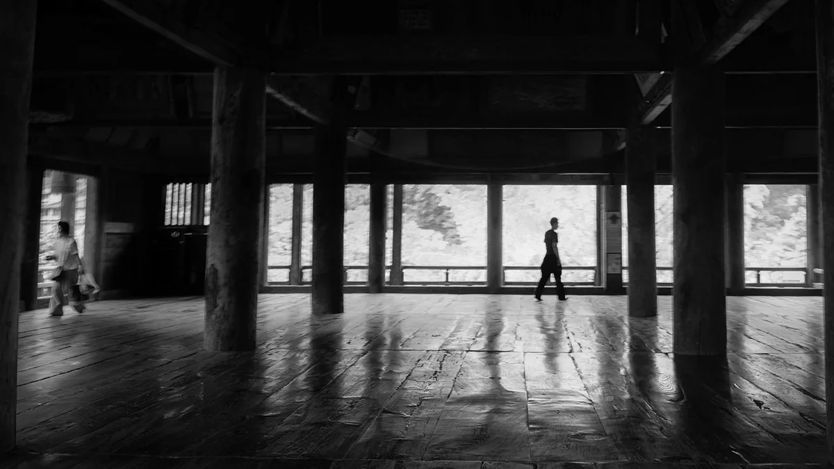 Black-and-white pavilion with a walking figure